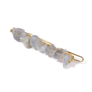 Detailed close-up of natural blue crushed stone hair clip with gold wire wrapping