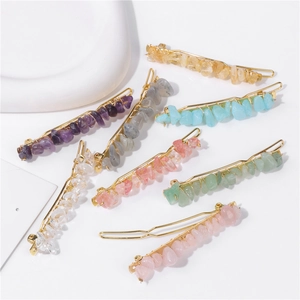 Detailed macro view of seven colorful natural stone hair clips on a golden metal base