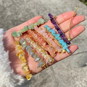 Close-up of assorted natural stone hair clips with colorful quartz on gold metal pins