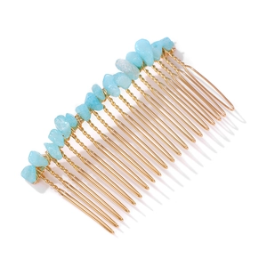 Detailed close-up of light blue natural stone fragments on a gold metal hair comb base