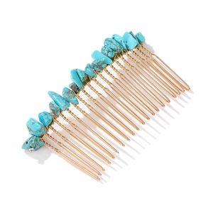 Detail of handmade gold metal hair comb with turquoise natural stones in boho style