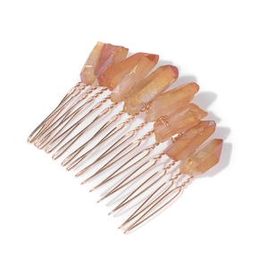 Detail view of natural orange quartz stones on a gold metal wire bridal hair comb