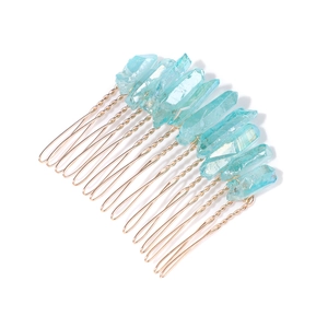 Close-up of light blue raw crystal stones hand-wired to a golden metal hair comb base