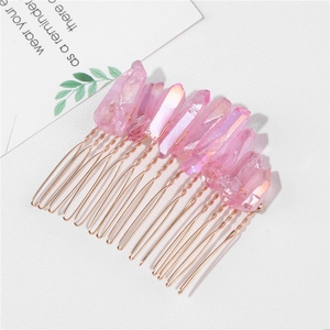 Detail of pink crystal hair comb with iridescent stones and golden wire wrapping
