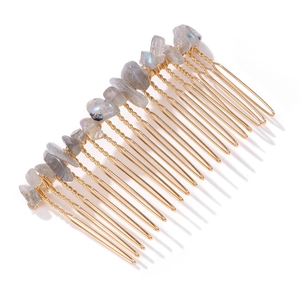 Detail of grey natural stone chips and golden wire weave on bridal hair comb