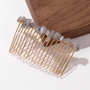 Detail of handmade gold hair comb with natural labradorite stones and wire wrapping