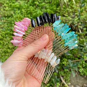 Close-up of handmade natural crystal hair pins with gold wire wrapping and raw stones