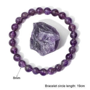 Detailed macro view of 8mm purple crystal beads and a natural stone bracelet