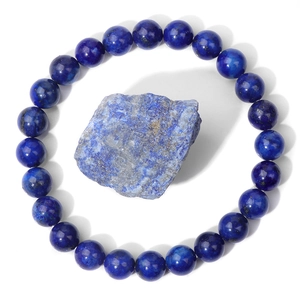 Macro detail of natural lapis lazuli beaded bracelet with raw stone mineral specimen