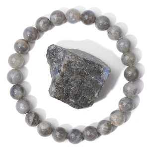 Macro shot of polished natural labradorite beads bracelet with blue flash raw stone