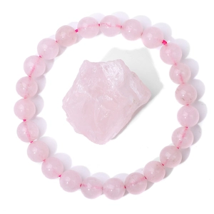 Macro detail of natural rose quartz beaded bracelet with unpolished raw pink energy stone