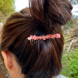 Handmade gold wire bridal hair comb with natural pink quartz stones on a brunette bun