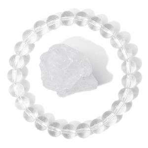 Macro detail of transparent natural crystal bead bracelet with a raw energy stone center