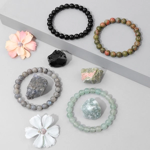 Set of four natural stone bead bracelets with raw mineral stones in various colors