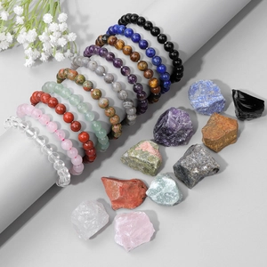Macro detail of natural stone bead bracelets set with matching raw healing crystals