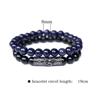 Detail view of 8mm natural stone beaded bracelets with vintage engraved metal tube