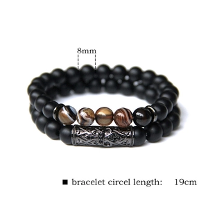 Macro detail of 8mm natural stone beaded bracelets showing black matte and agate texture