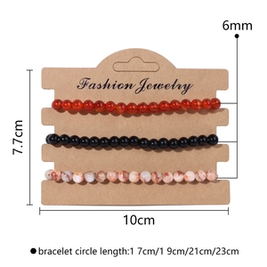 Detail view of 3-piece natural stone bead bracelets set on a cardboard display