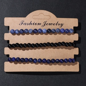 Detailed macro view of three natural stone beaded bracelets on a display card