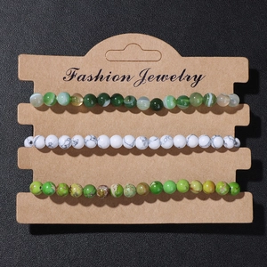 Close-up of three-piece natural stone bead bracelet set on a display card