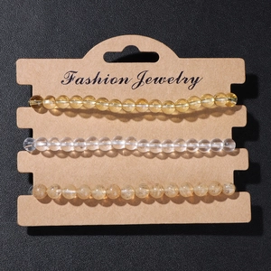 Detailed macro of a 3-piece natural stone bead bracelet set on a display card
