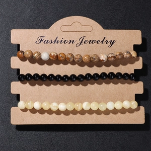Detailed set of three 4mm natural stone beaded bracelets on brown display card