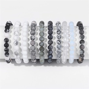 Detail view of 10 assorted 8mm natural stone bead bracelets on a white display stand