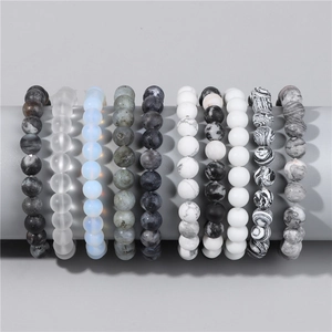Detailed display of ten 8mm natural stone beaded bracelets with various textures and colors