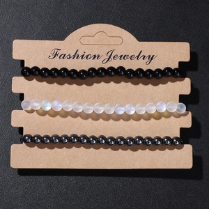 Detailed view of three-piece 4mm natural stone beaded bracelets on Fashion Jewelry card