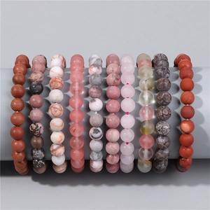 Detail showing various 8mm natural stone beaded bracelets with elastic cord on display