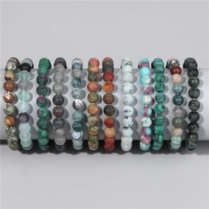 Detail showing 12-piece natural 8mm stone bead bracelet set on a grey display stand