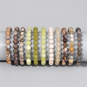 Detailed collection of 12 natural stone bead bracelets in various earthy tones and textures