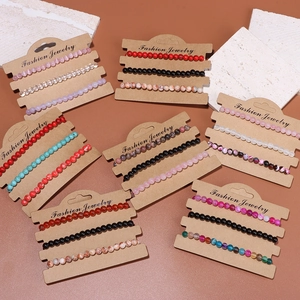 Detailed close-up of beaded elastic bracelets featuring natural stones on display cards