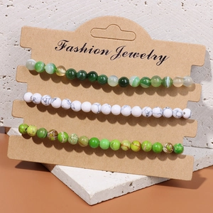 Three-piece set of natural stone bead stretch bracelets on a fashion jewelry display card