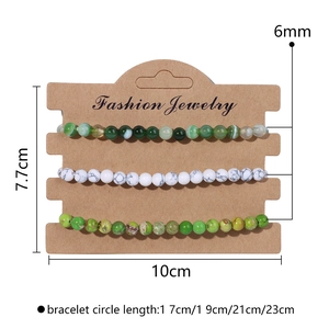 Three-piece set of 6mm natural stone beaded bracelets on card display for women