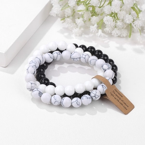 Three-piece stretch bead bracelet set with black agate, white marble, and cat eye stone