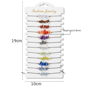 Set of 12 natural stone bead bracelets with adjustable strings on a white display card