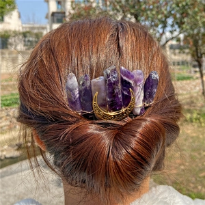 Handmade amethyst crystal hair clip with a golden moon on a bohemian braided hairstyle