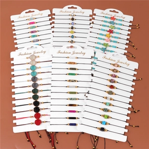 Detail of adjustable woven cord bracelets with natural stone beads and starfish charms