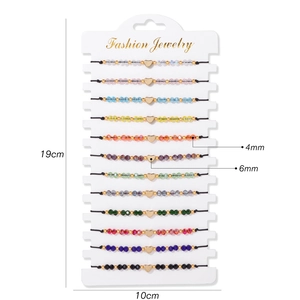 Set of 12 colorful braided heart bracelets with adjustable ropes on display card