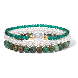 Detail view of a three-layer beaded bracelet set with green natural stones and pearls