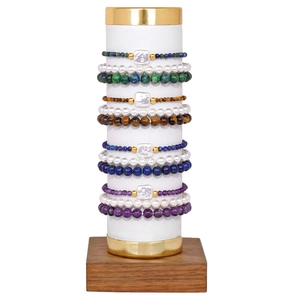 Detail view of multi-layered beaded bracelets with natural stones and baroque pearls