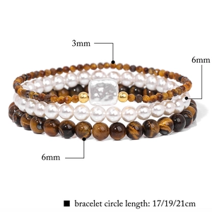 Detail of a 3-piece layered bracelet set with tiger eye stones and white pearls