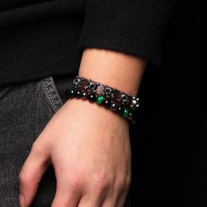 Punk leather bracelet set with silver skulls and tiger eye beads on male wrist