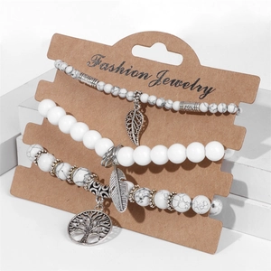 Detailed set of 3 bohemian beaded bracelets featuring tree of life and feather charms