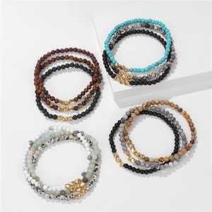 Detailed macro view of 4mm natural stone bead bracelet set with golden spacers