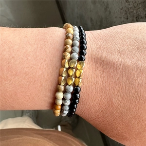Close-up of three-piece beaded bracelet set featuring natural stone textures and gold accents