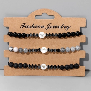 Set di 3 bracciali con perline di pietra lavica nera, marmo e icone a forma di stella