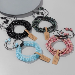Detail of four natural stone bead bracelets with adjustable black braided cords