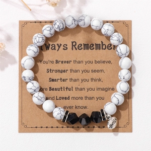Detail view of WISH heart pendant on 8mm marble beads bracelet with Kraft quote card